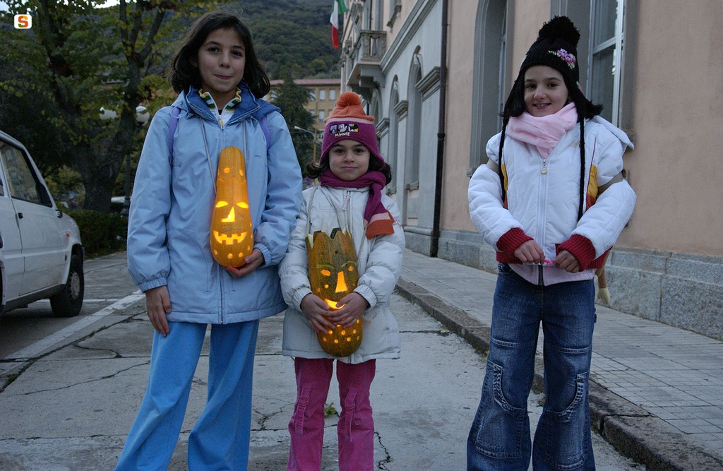 Bambine con la zucca intagliata e illuminata da una candela
